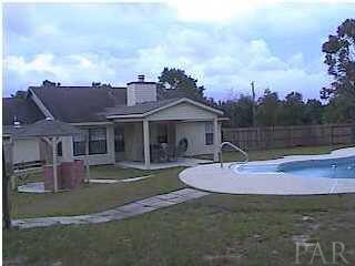 6721 Bellview Pines Road Pensacola, FL 32526 - Photo 6 of 6 Large backyard with pool, covered patio, outdoor BBQ area and pool side bathroom area.