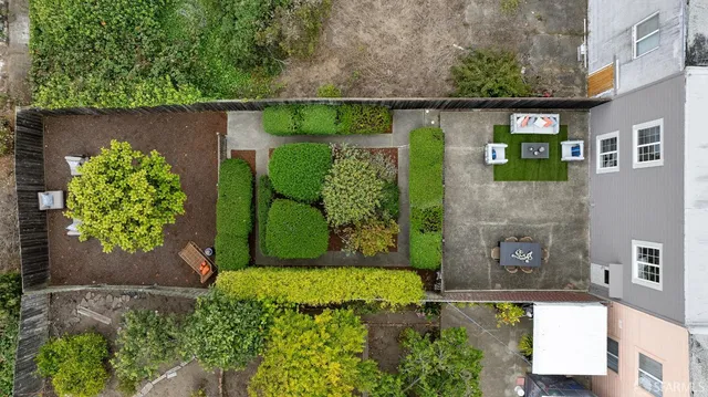 a backyard of a house with a table and chairs