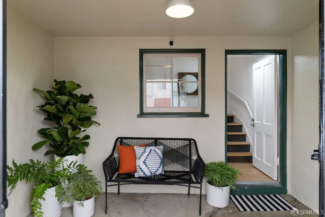 a living room with furniture and a book shelf