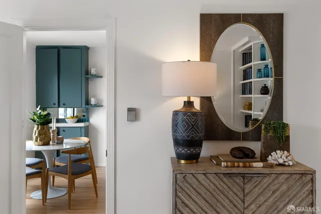 a kitchen with a refrigerator a table and chairs in it