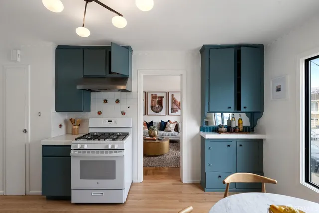 a kitchen with stainless steel appliances a sink stove and refrigerator