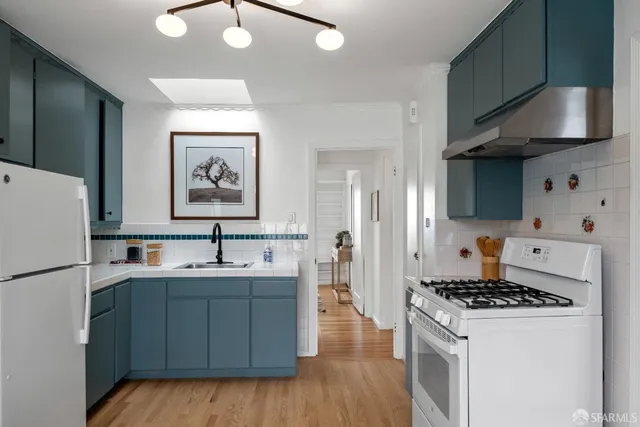 a bedroom with bed and a chandelier