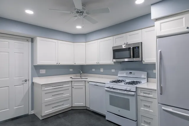 a kitchen with appliances cabinets and a sink