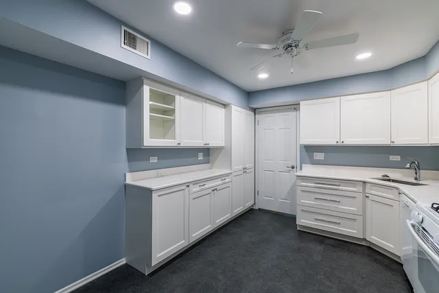 a kitchen with a sink cabinets and window