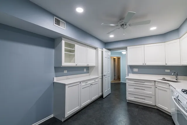 a kitchen with a sink stainless steel appliances and cabinets