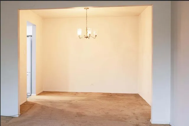 a view of an empty room and a window