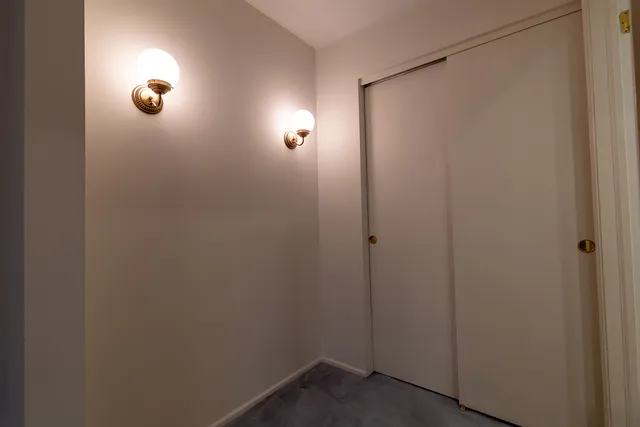 a bathroom with a sink toilet vanity and window