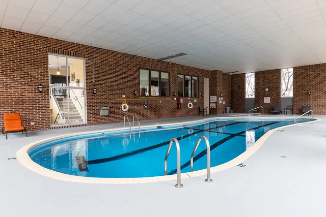a room with furniture and large windows