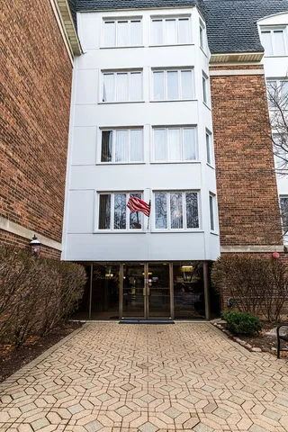 a front view of a building with a bench
