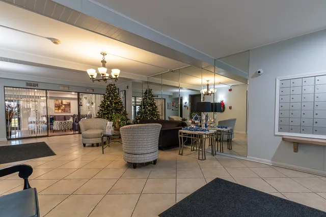 a dining room with furniture a chandelier and fireplace