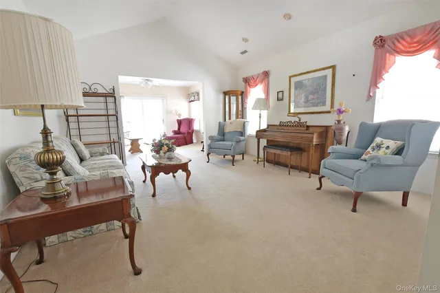 a living room with furniture and a lamp