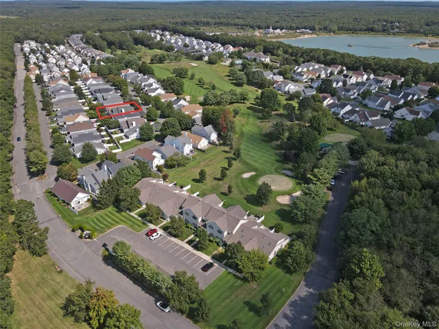 a view of a hallway with wooden floor and cabinet