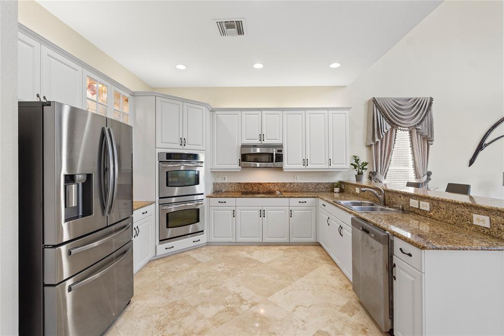 4622 Southwest 185th Avenue Miramar, FL 33029 - Photo 15 of 64 a large kitchen with stainless steel appliances granite countertop a stove top oven a sink and dishwasher