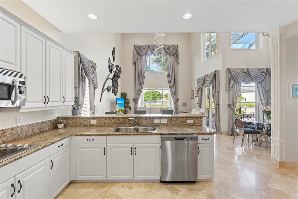 4622 Southwest 185th Avenue Miramar, FL 33029 - Photo 17 of 64 a kitchen with stainless steel appliances granite countertop a stove a sink and a granite counter tops