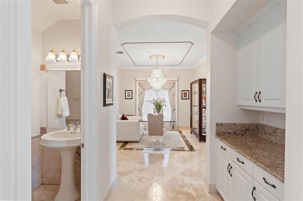 4622 Southwest 185th Avenue Miramar, FL 33029 - Photo 23 of 64 a large white kitchen with a granite countertop sink and a mirror