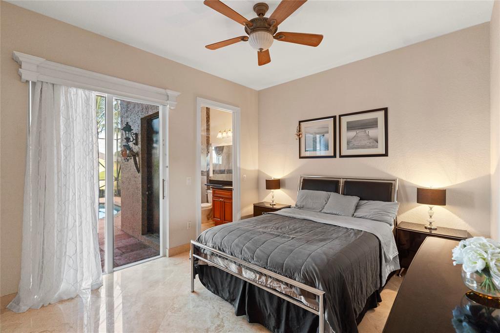 4622 Southwest 185th Avenue Miramar, FL 33029 - Photo 31 of 64 a bedroom with a bed and a chandelier