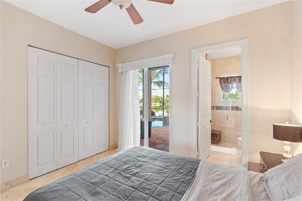 4622 Southwest 185th Avenue Miramar, FL 33029 - Photo 32 of 64 a bedroom with a bed and a chandelier fan