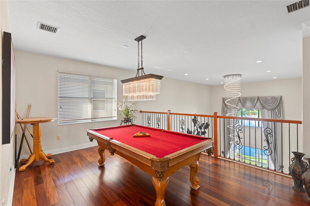 4622 Southwest 185th Avenue Miramar, FL 33029 - Photo 37 of 64 a room with pool table windows and wooden floor