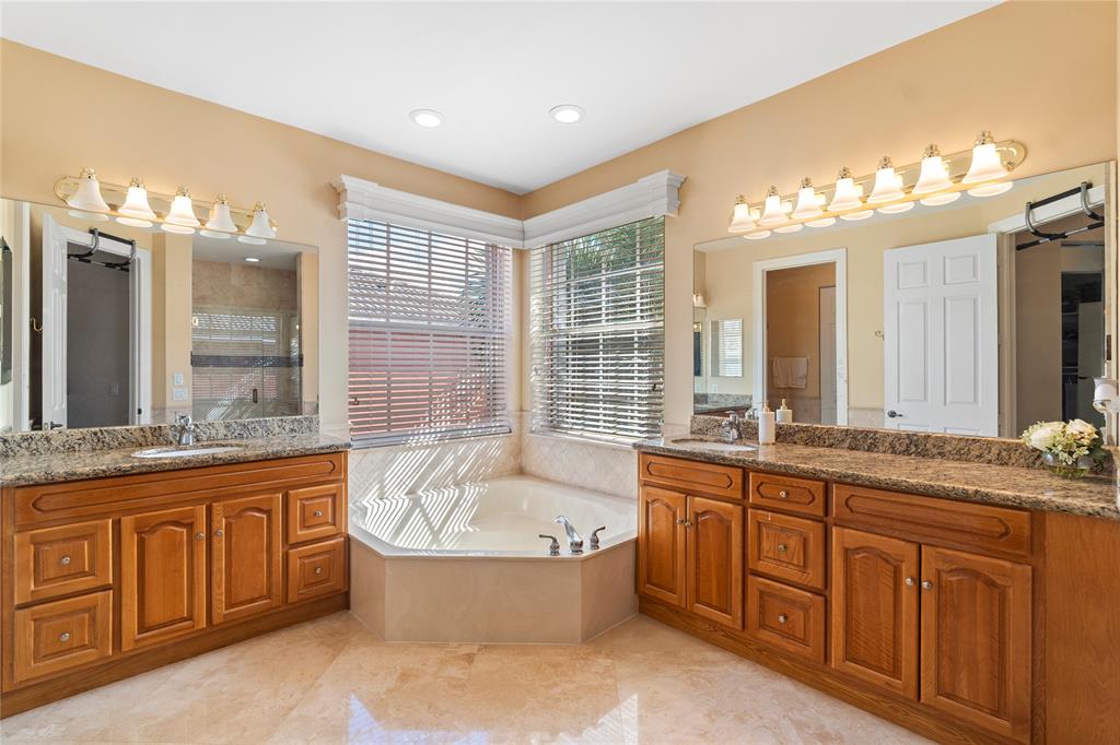 4622 Southwest 185th Avenue Miramar, FL 33029 - Photo 44 of 64 a spacious bathroom with a granite countertop tub sink and mirror