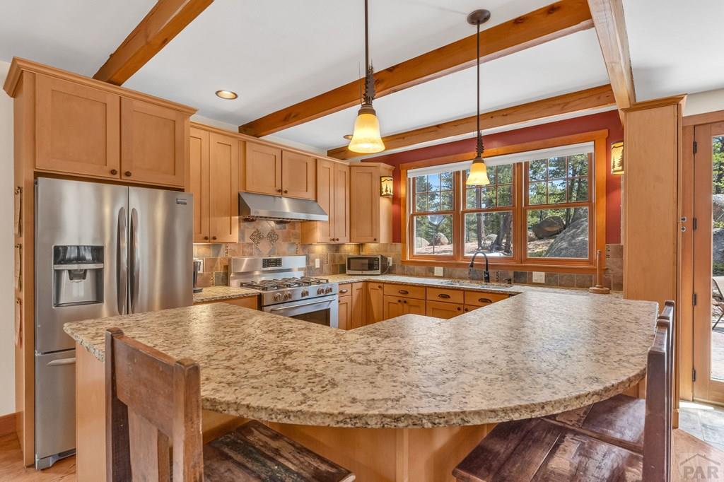 10 Robert Road Rye, CO 81069 - Photo 16 of 102 a kitchen with stainless steel appliances granite countertop a sink a stove and refrigerator