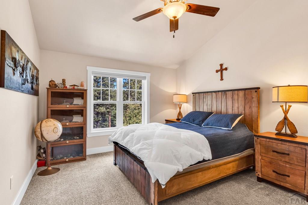 10 Robert Road Rye, CO 81069 - Photo 44 of 102 a bedroom with a bed and a chandelier