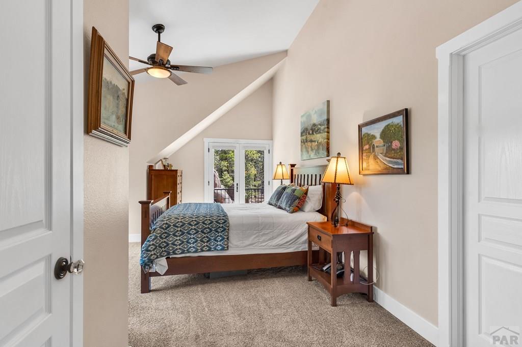 10 Robert Road Rye, CO 81069 - Photo 49 of 102 a bedroom with a bed and a chandelier
