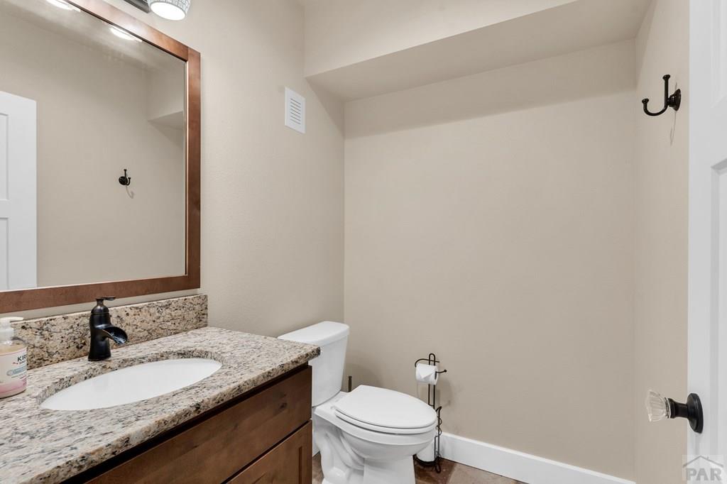 10 Robert Road Rye, CO 81069 - Photo 64 of 102 a bathroom with a granite countertop sink a toilet and a mirror