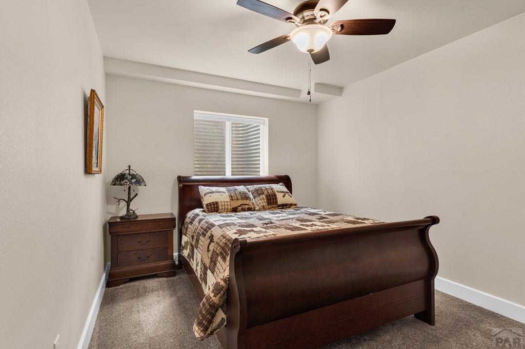 10 Robert Road Rye, CO 81069 - Photo 65 of 102 a bedroom with a bed and a chandelier