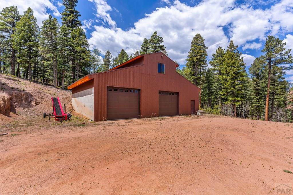 10 Robert Road Rye, CO 81069 - Photo 75 of 102 a front view of a house with a yard and garage