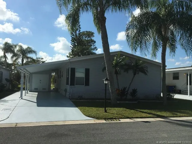 a house with palm tree in front of it