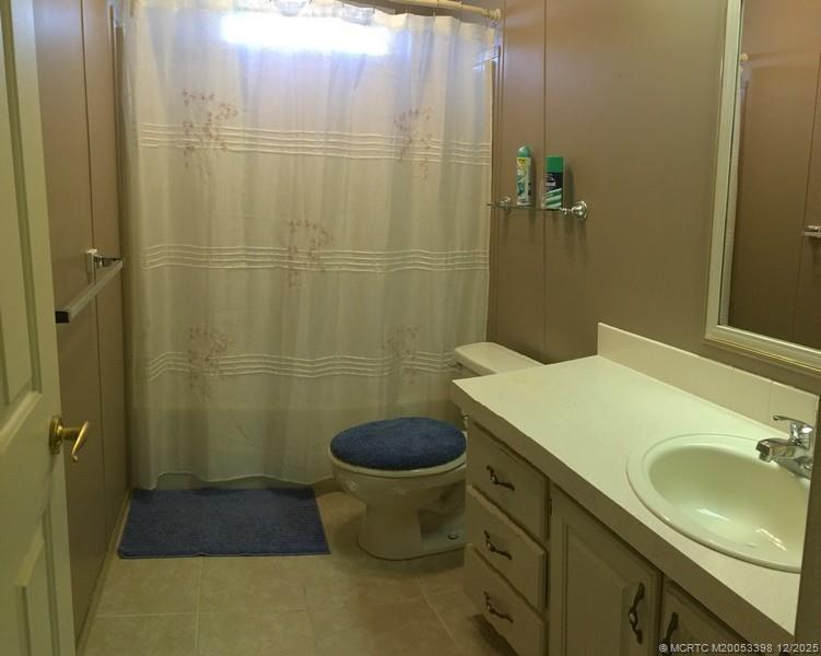 16152 Southwest Five Wood Way Indiantown, FL 34956 - Photo 6 of 9 a bathroom with a sink toilet and shower