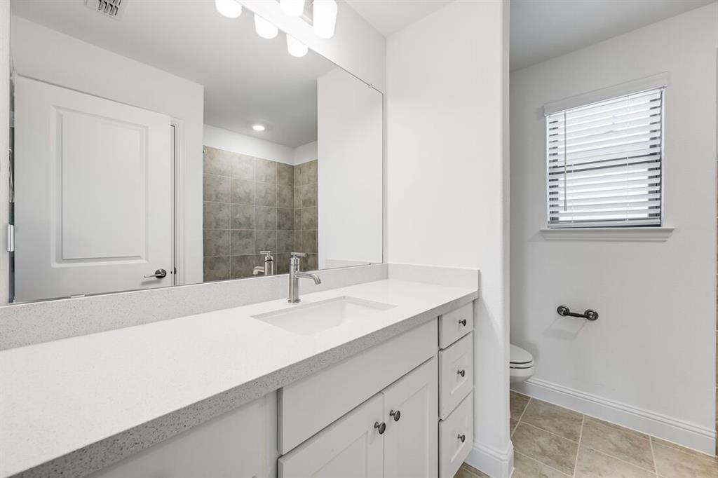 614 Bull Street Oak Point, TX 75068 - Photo 12 of 36 a bathroom with a sink and a mirror