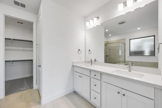 a bathroom with a double vanity sink and mirror