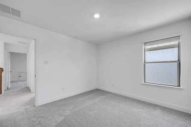 an empty room with a empty space and windows