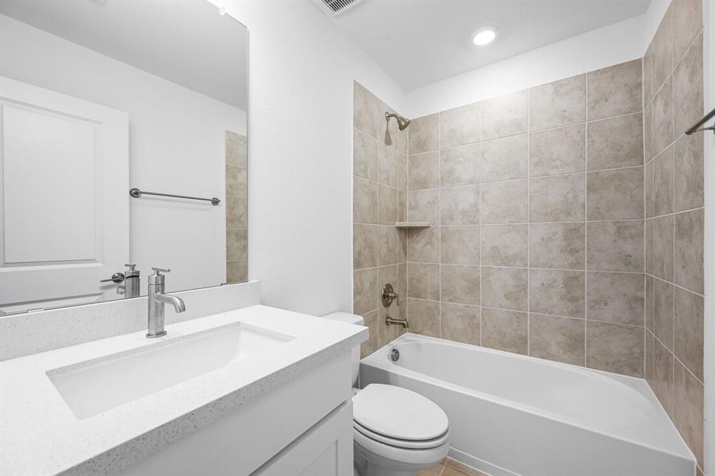 614 Bull Street Oak Point, TX 75068 - Photo 23 of 36 a bathroom with a bathtub shower sink mirror vanity and toilet