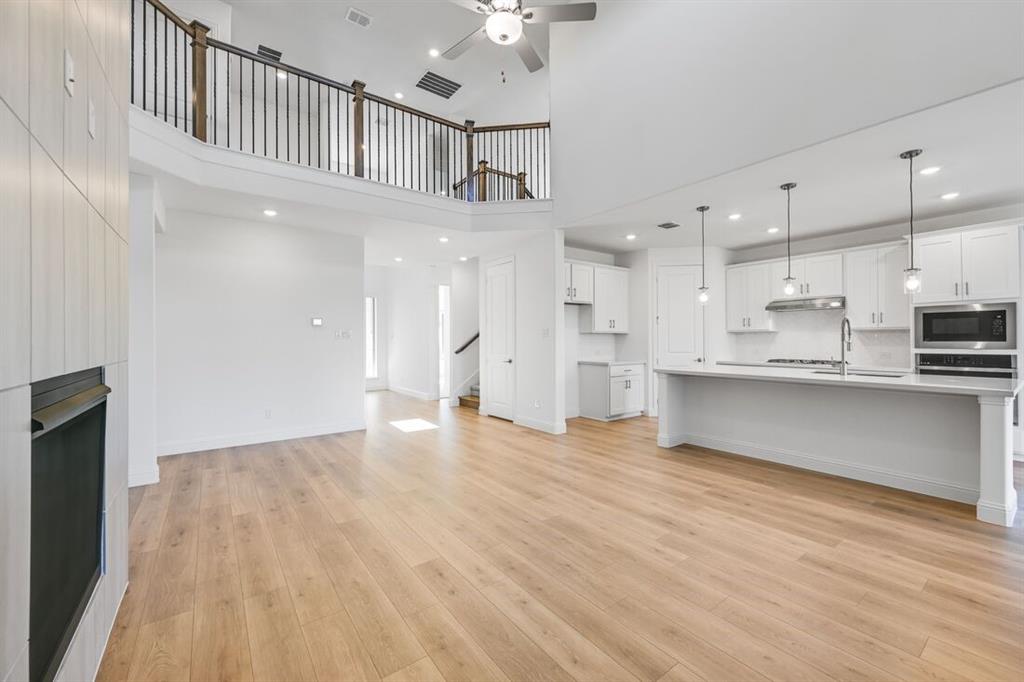 614 Bull Street Oak Point, TX 75068 - Photo 8 of 36 a view of kitchen with kitchen island wooden floor center island and stainless steel appliances