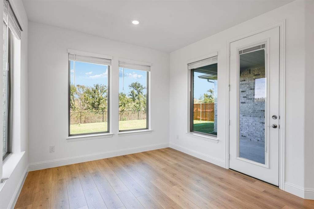 614 Bull Street Oak Point, TX 75068 - Photo 9 of 36 an empty room with wooden floor and windows