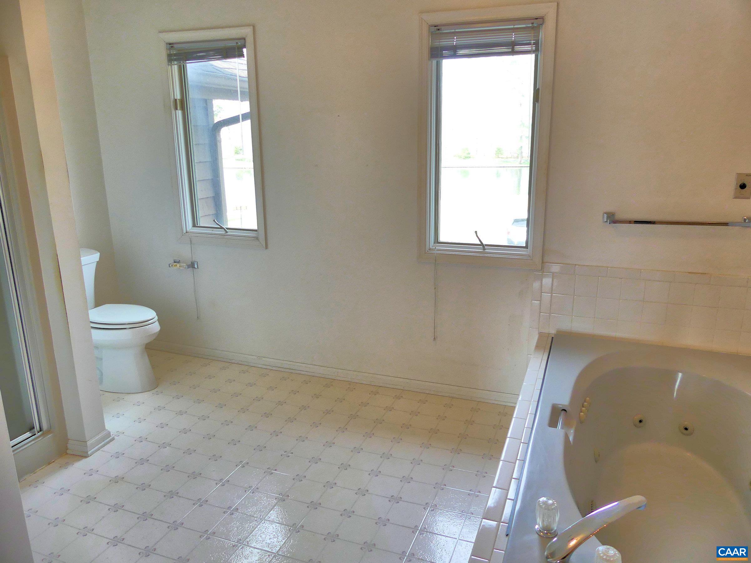 2 Marina Point Palmyra, VA 22963 - Photo 22 of 32 a bathroom with a toilet sink and window