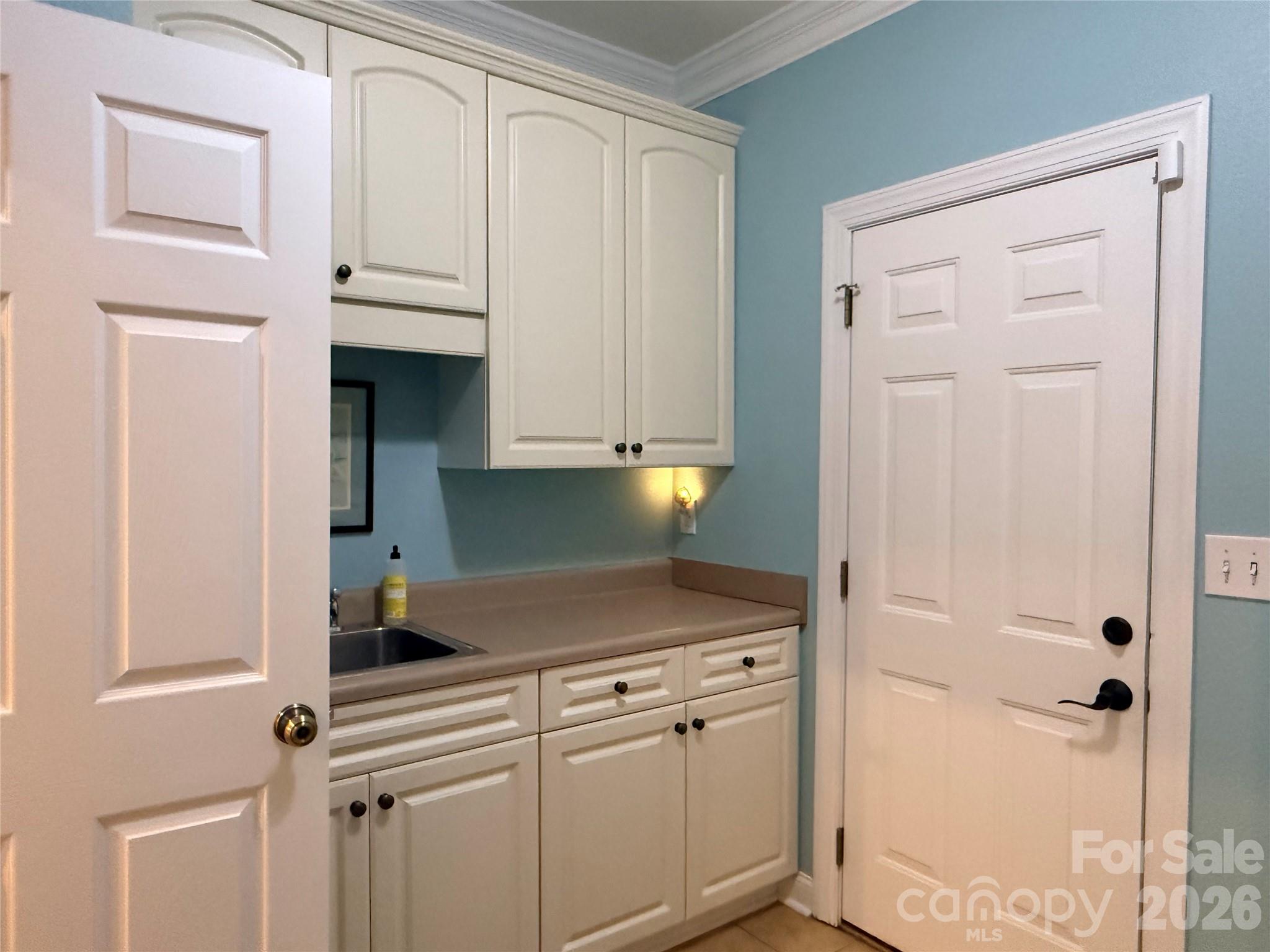 183 Burl Bridges Road Forest City, NC 28043 - Photo 20 of 33 a kitchen with white cabinets and white appliances