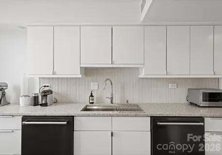 a living room with furniture and floor to ceiling windows