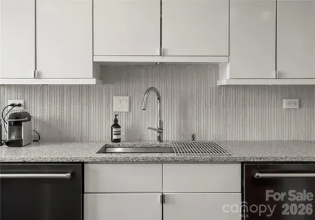 a view of a kitchen with a sink and cabinets