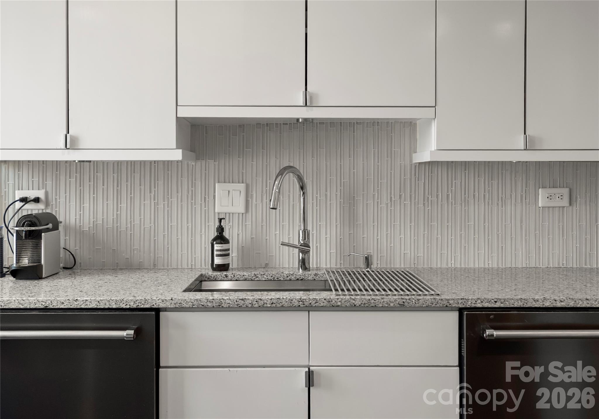 1300 Queens Road Charlotte, NC 28207 - Photo 18 of 45 a kitchen with granite countertop white cabinets and a sink