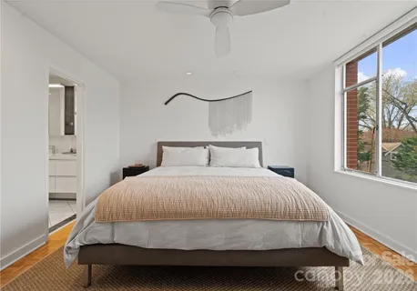 a bedroom with a bed and a night stand