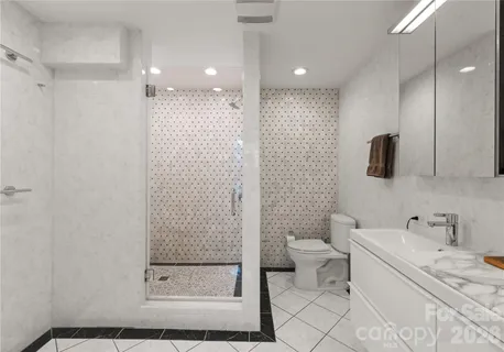 a bathroom with a sink a toilet and a mirror