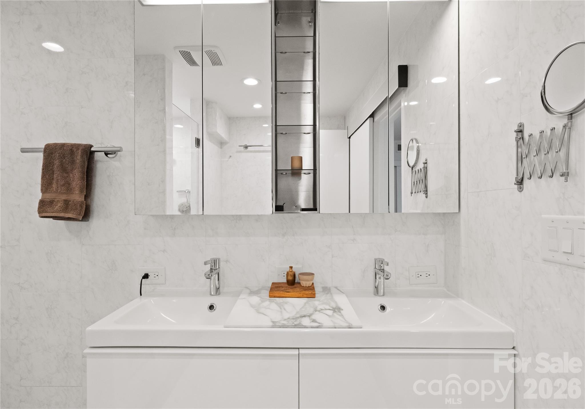 1300 Queens Road Charlotte, NC 28207 - Photo 30 of 45 a bathroom with a sink a mirror and shower