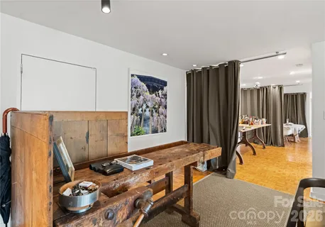 a bedroom with furniture and a large window