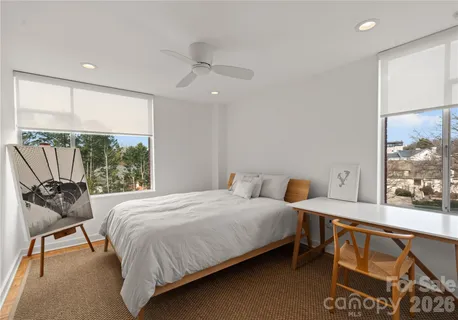 a bed sitting in a bedroom next to a window