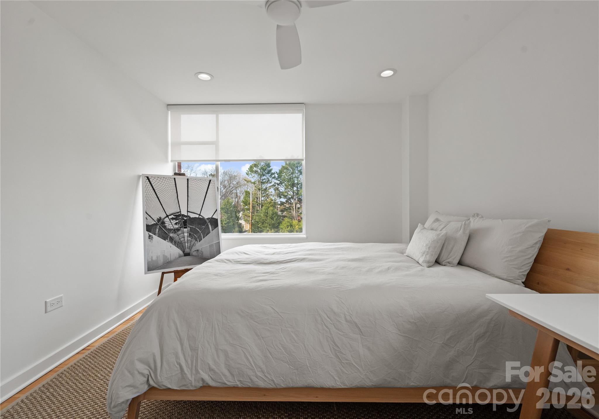 1300 Queens Road Charlotte, NC 28207 - Photo 33 of 45 a bed sitting in a bedroom next to a window