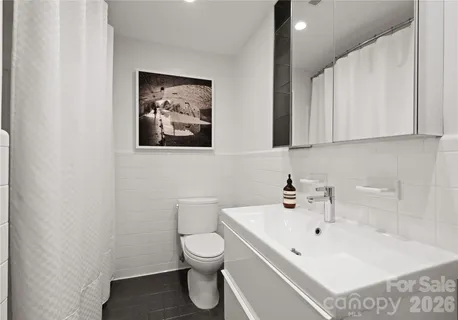 a bathroom with a glass shower door