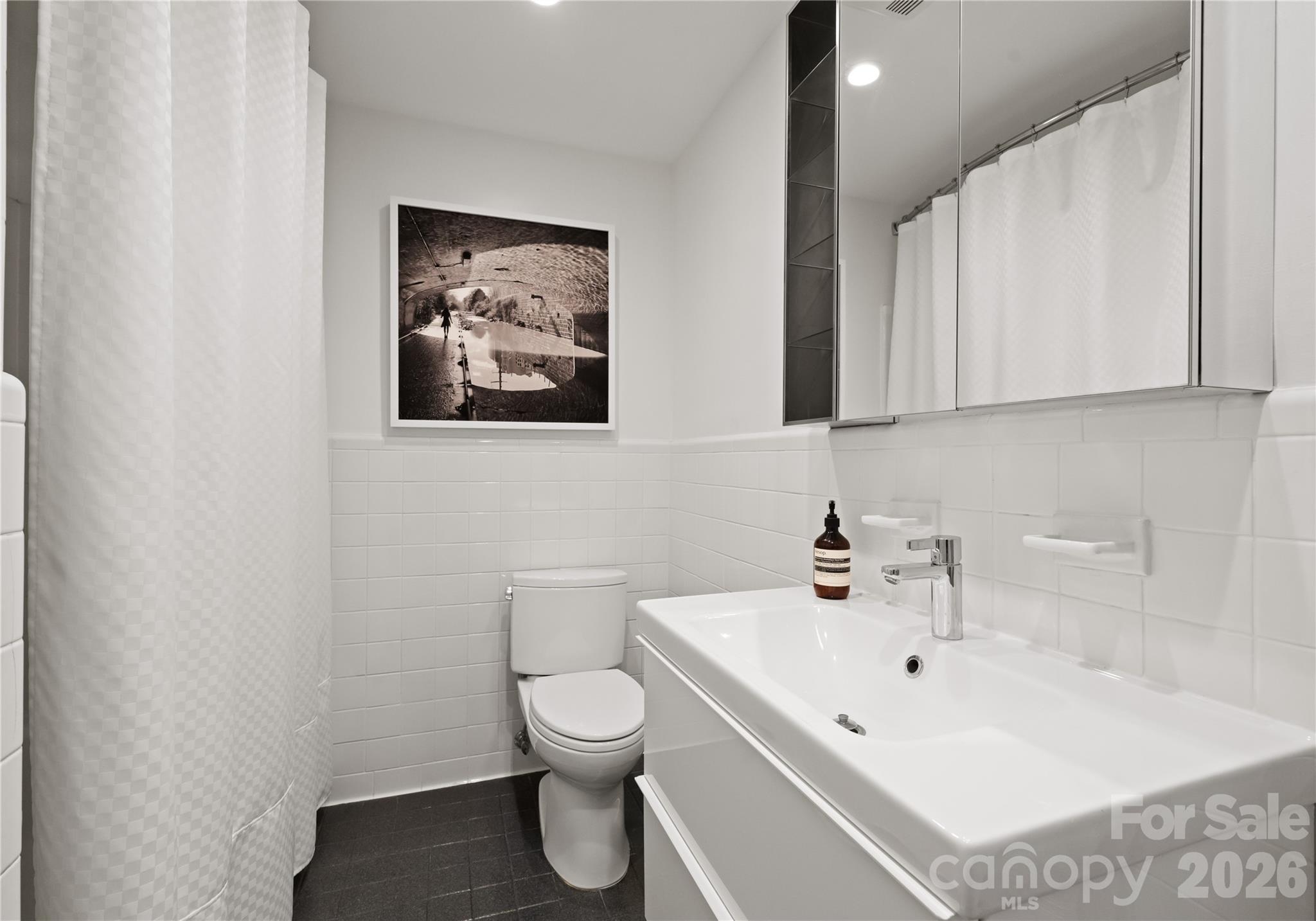 1300 Queens Road Charlotte, NC 28207 - Photo 35 of 45 a white toilet sitting next to a bathroom sink